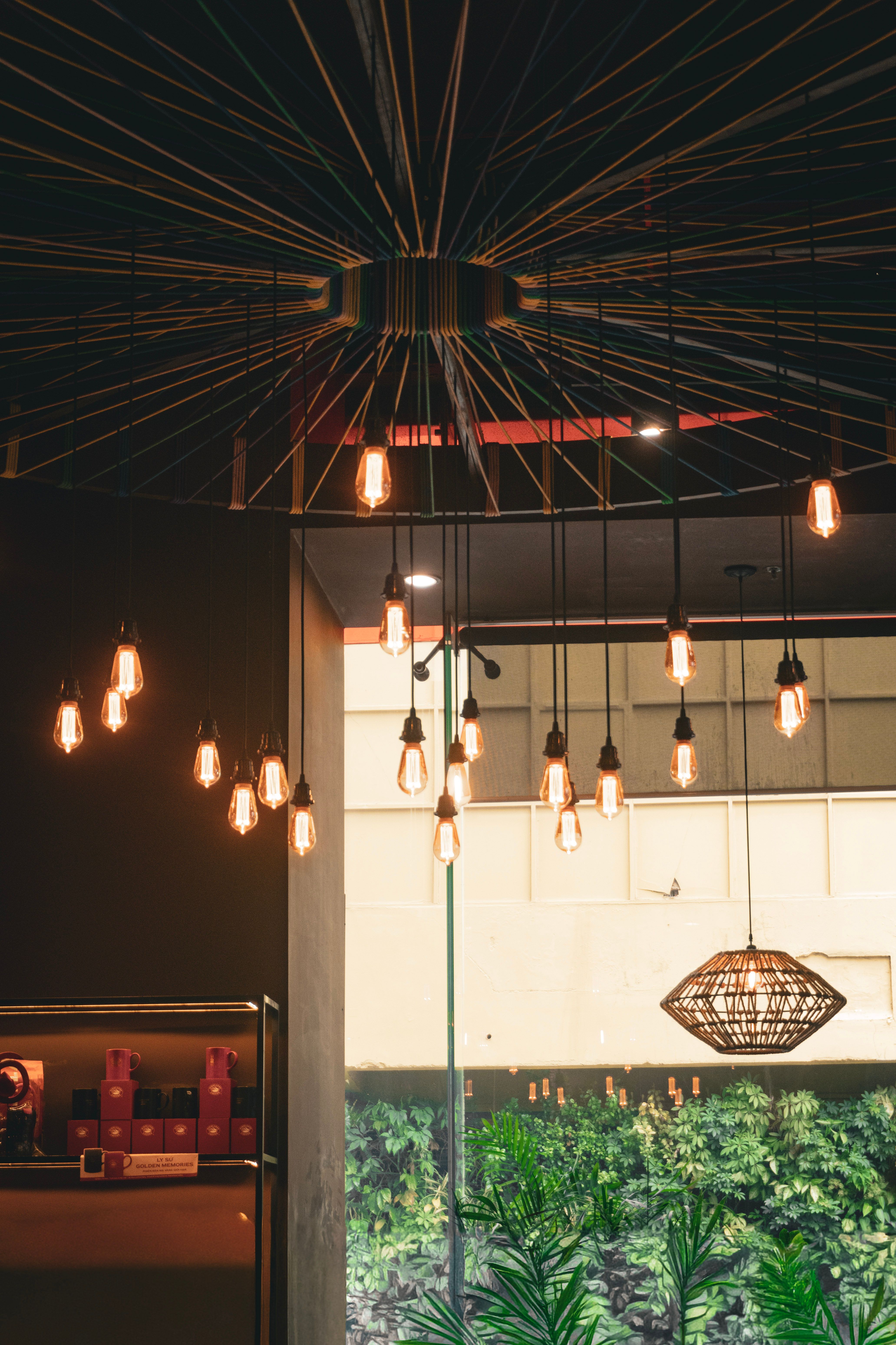 Designer pendant lighting installation with exposed bulb wiring in a residential space Designer pendant lighting installation with exposed bulb wiring in a residential space