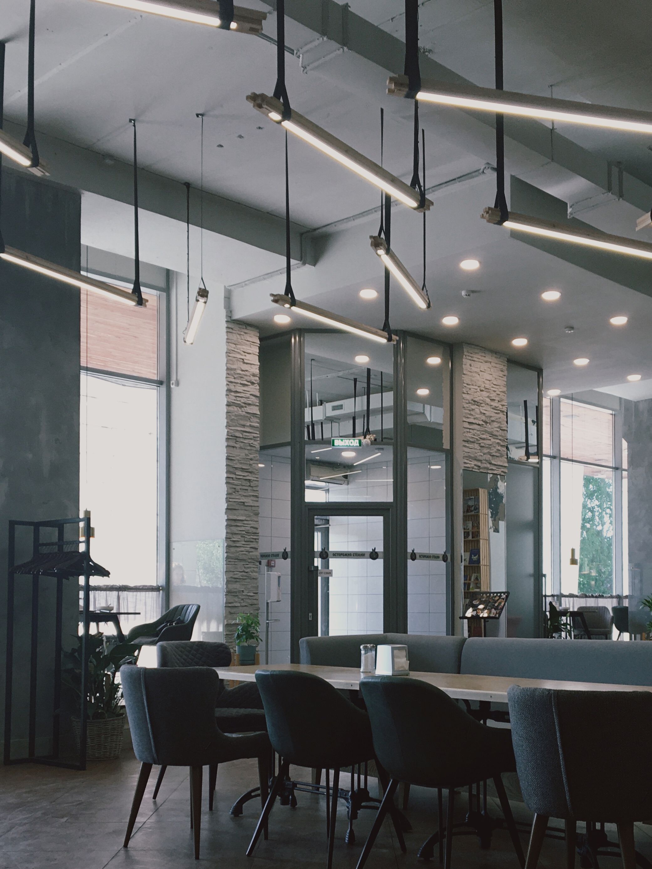 Commercial interior with exposed ceiling and designer pendant lighting by Beyond Briks