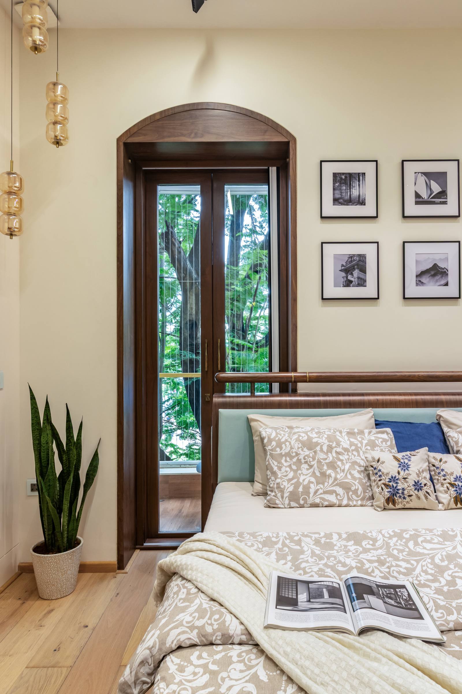Arched wooden window feature with framed gallery wall in a Beyond Briks luxury bedroom Arched wooden window feature with framed gallery wall in a Beyond Briks luxury bedroom