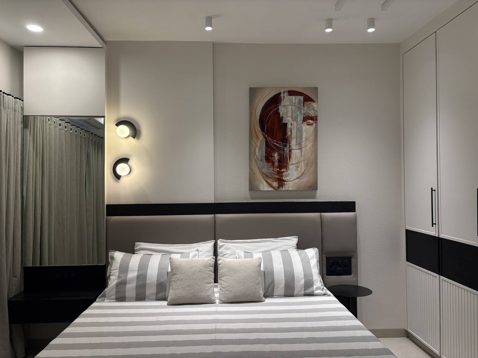 Bedroom with statement wall art and upholstered headboard by Beyond Briks Bedroom with statement wall art and upholstered headboard by Beyond Briks