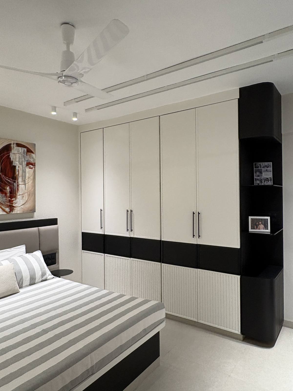 Two-tone wardrobe wall in a contemporary bedroom by Beyond Briks