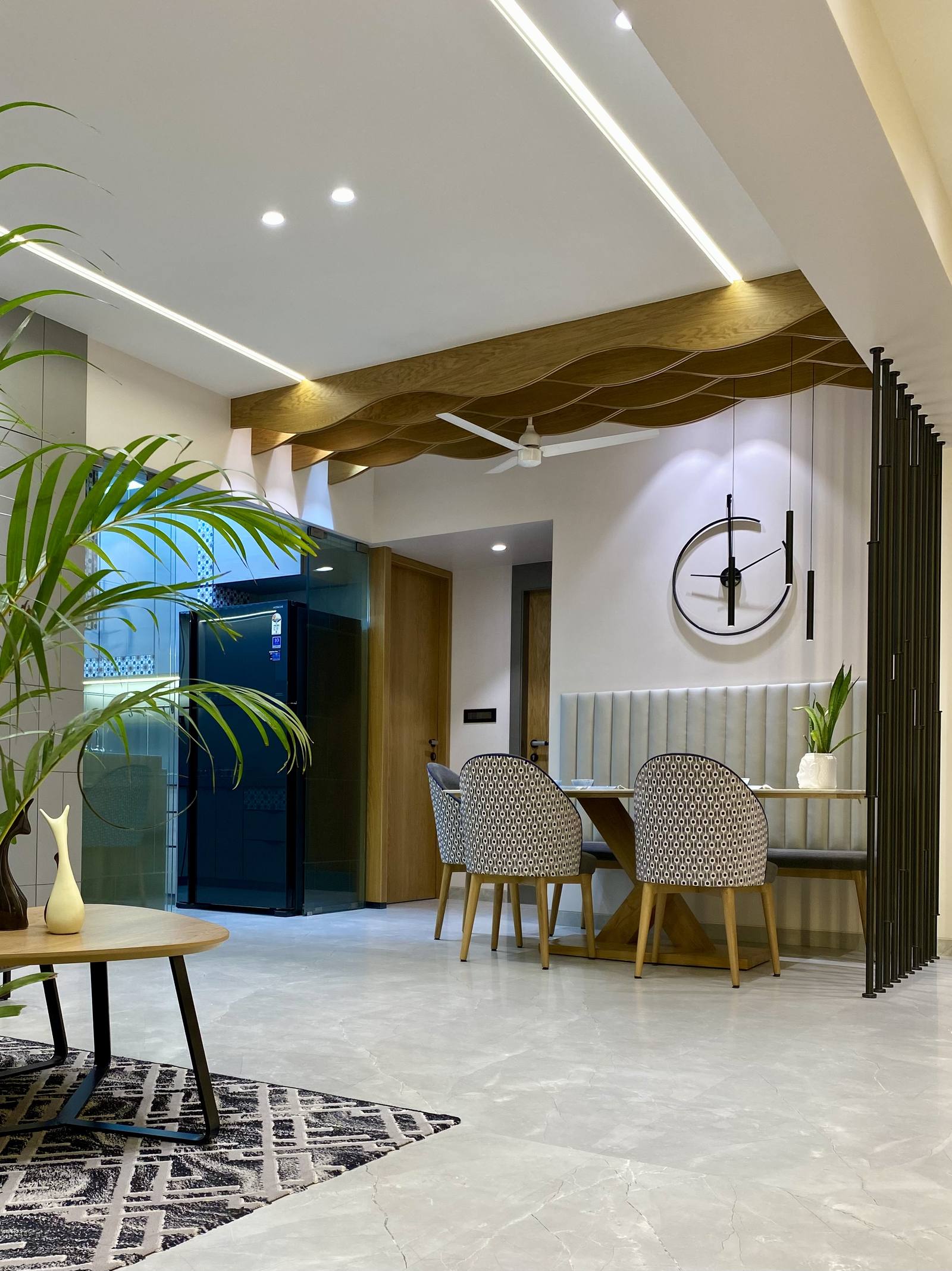 Sculptural wave false ceiling in a luxury living and dining space by Beyond Briks Sculptural wave false ceiling in a luxury living and dining space by Beyond Briks