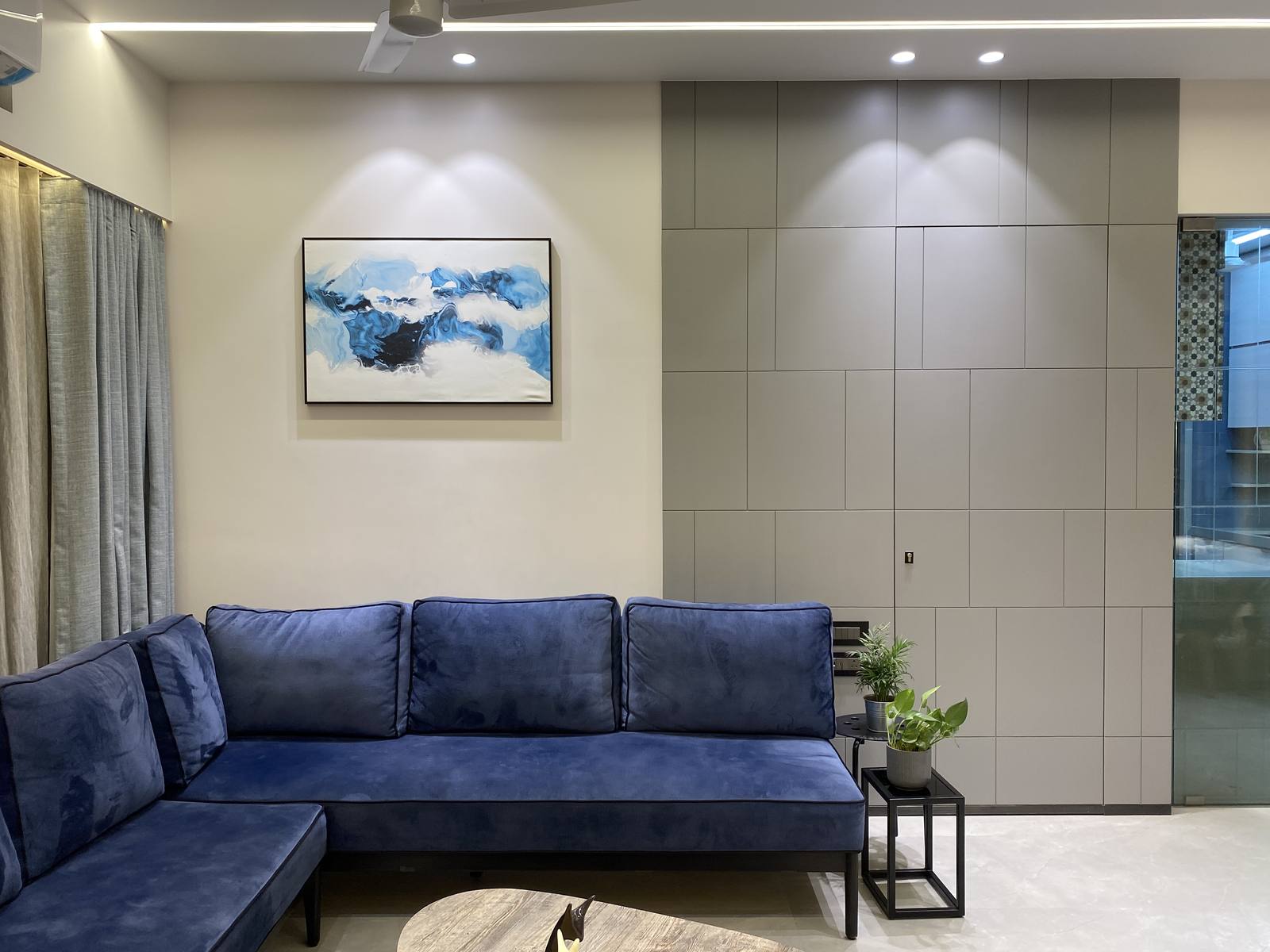 Living room with navy velvet sectional sofa and abstract art by Beyond Briks Living room with navy velvet sectional sofa and abstract art by Beyond Briks